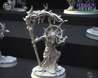 May include: A gray, skeletal, undead sorceress miniature figure with a staff, a book, and a skull. The figure is standing on a round base with a cracked surface. The figure is part of the Hidden Crypt collection.