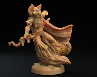 May include: A painted miniature figurine of a fox-like creature wearing a cloak and holding a staff. The creature is in mid-air, with its cloak billowing behind it. The figurine is painted in shades of brown and tan.