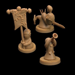 May include: Three miniature figurines, painted in brown, depicting a snail with a rider, a figure holding a flag, and a figure playing a trumpet. The figures are on circular bases.