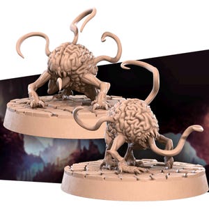 May include: Two 3D printed miniature brain-like creatures with multiple tentacles, standing on circular bases with a textured surface.