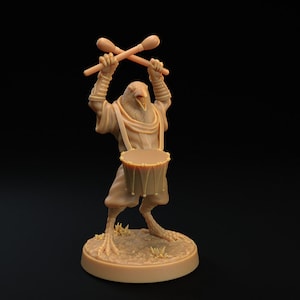 May include: A brown, bird-like creature with a drum and drumsticks. The creature is wearing a brown robe and has a beak open in a singing pose. The creature is standing on a brown base.