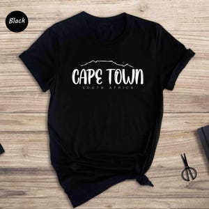 a black t - shirt with cape town written on it