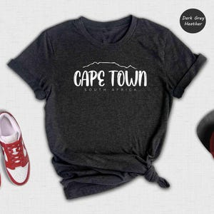 a t - shirt that says cape town and a pair of red shoes