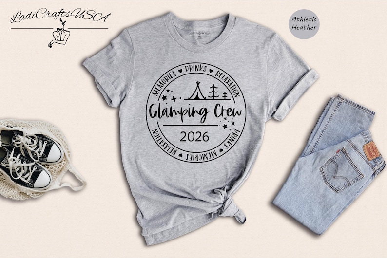 a gray t-shirt with a graphic design, a pair of jeans, and some accessories such as a pair of sneakers and a handbag.