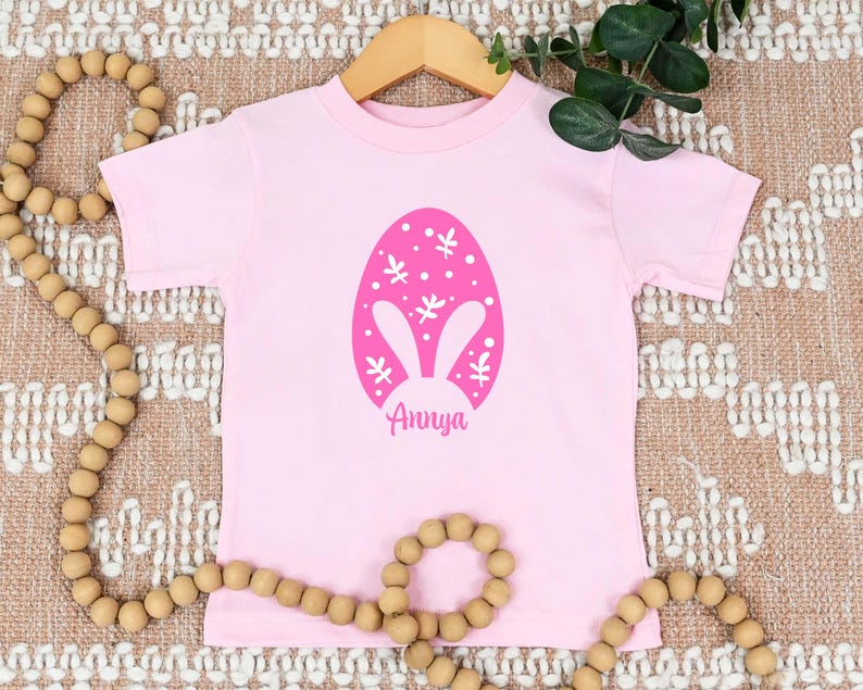 a pink t - shirt with an easter egg on it