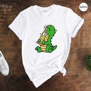Dino Lover Gift Tee: Dinosaur Eating Pizza Design, Funny Dino Pizza Shirt | Cotton Blend, Unisex Sizes XS-XXL image 1