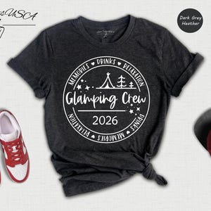 a black t-shirt with white text and graphics, a pair of red sneakers, a red baseball cap, and a black and white graphic of a tent.