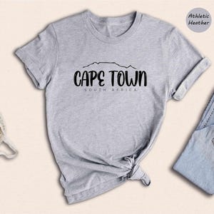 a t - shirt that says cape town with a pair of sneakers