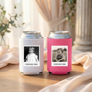 Two vintage-style can holders, one white and one pink, each featuring a black and white photograph of a young child.