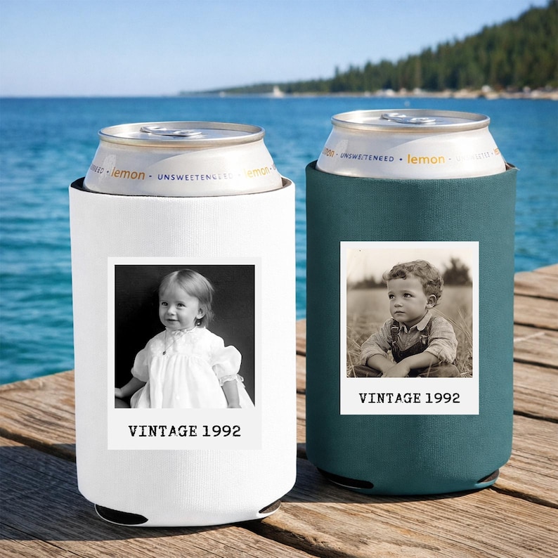Two vintage-style can holders with black and white photographs of children, placed on a wooden dock overlooking a body of water.
