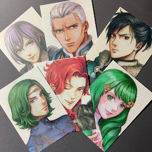 May include: A collection of six rectangular art prints featuring detailed coloured pencil illustrations of various characters. Each portrait displays distinct facial features, hair colours including purple, silver, black, green, and red, and unique attire.