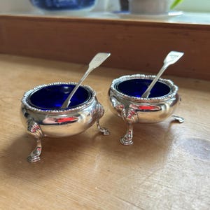 Pair Serling Silver salts and spoons, salts marked for IW, London 1758 George II Width 6cm, spoons for Isaac Parkin, Exeter 1830 George IV