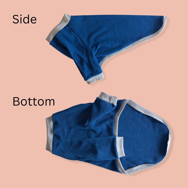 May include: A blue dog sweater with gray trim. The sweater is shown from the side and bottom.
