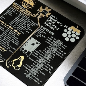 May include: Black Raspberry Pi cheat sheet with gold graphics and text. It includes system information, disk utilities, and a guide for the Raspberry Pi Linux operating system. Features a diagram of the Pi's pin layout.