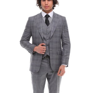 May include: A gray checkered suit with a black and white striped tie. The suit jacket has a three-button closure and a single vent in the back. The suit pants have a flat front and a slim fit.