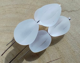 May include: Four opaque white glass beads with a frosted finish, strung on silver wire.