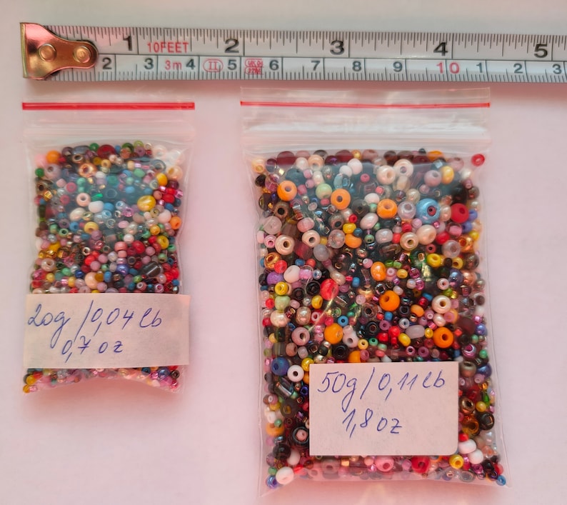 May include: Two bags of colorful seed beads. The smaller bag contains 209 beads weighing 0.7 ounces and the larger bag contains 50 grams of beads, which is 0.1126 pounds or 1.8 ounces.