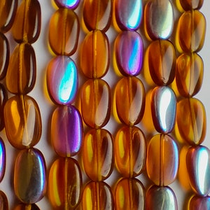 13 Topaz oval beads 14x8mm, AB finish Czech glass pressed barrel beads, Czech glass beads in topaz and half rainbow wash, Bohemian glass