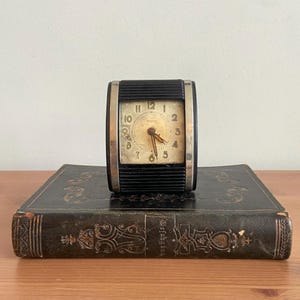 Vintage 1970s travel fold up alarm clock - not tested - 3.5” x 1.5” - retro collectable clock