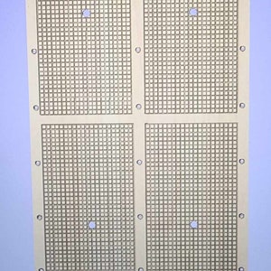 May include: A wooden board with four sections, each with a grid pattern of small squares. There are four circular holes in the board, one in each section.