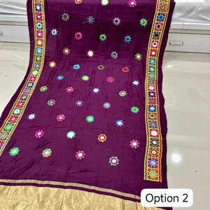 May include: A deep purple textile with colorful embroidered mirror accents. The fabric features a gold border and trim with the text "Option 2". The design includes a repeating pattern of small mirrors and embroidered details.