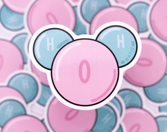 May include: A sticker depicting a water molecule in a cartoon style. The central pink circle has a large "0" inside, with two smaller blue circles with "H" and "WATER" text. The design is repeated in the background.
