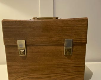 Vintage 1970’s   Record Case designed to carry 50 x 12” vinyl records . Finished in a Teak faux wood .
