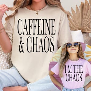 May include: A beige t-shirt with the text "CAFFEINE & CHAOS" in black. A smaller image shows a pink t-shirt with the text "I'M THE CHAOS". The shirts are casual wear.