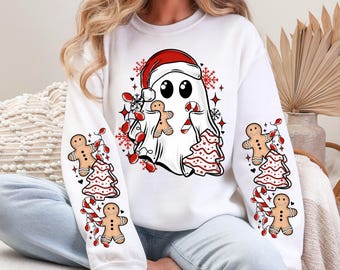 May include: White sweatshirt with a Christmas ghost design. The ghost wears a Santa hat and holds a gingerbread man and candy cane. Sleeves feature gingerbread men, Christmas trees, and candy canes. The word "White" is at the top.