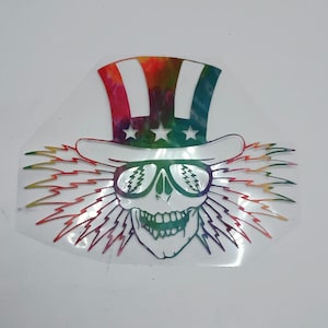 May include: A colorful, tie-dye Uncle Sam sticker with a skull wearing sunglasses and a lightning bolt design.