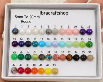 May include: A variety of 43 round beads in a white box, ranging from 5mm to 20mm. The beads are in various colors, including pink, green, blue, and brown. The text "Ibracraftshop" and "5mm To 20mm Round" are visible.