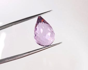 May include: A teardrop-shaped, faceted amethyst gemstone in a light purple color.