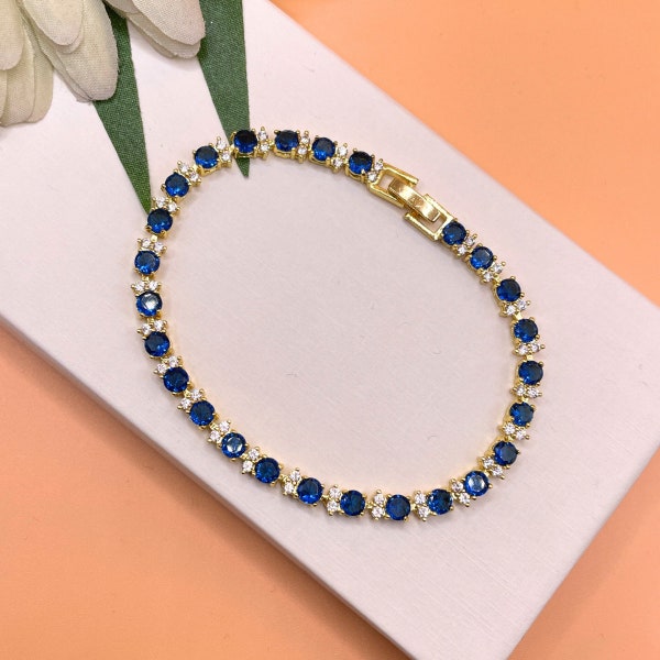 Yellow gold finish Blue Sapphire and created diamonds round cut tennis bracelet