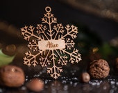 Personalized wooden Christmas balls in the shape of a snowflake