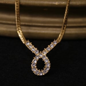 Vintage rhinestone teardrop loop pendant necklace Gold tone herringbone chain Avon Plaza collection