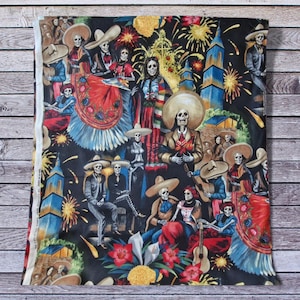 May include: A fabric panel featuring a vibrant Day of the Dead design. The artwork depicts skeletons in festive attire, mariachi musicians, and fireworks against a black background. Colorful flowers and architectural elements add to the celebratory theme.