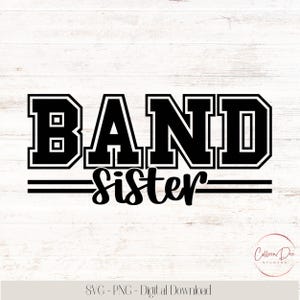 May include: Black and white graphic design with the words "BAND Sister" in a bold, collegiate-style font. The word "BAND" is stacked above "Sister", with two horizontal lines separating the words. The design is set against a light wood grain background.