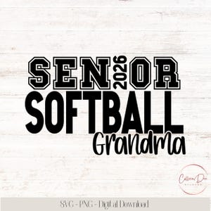May include: Black and white graphic design with the words "SENIOR SOFTBALL Grandma 2026" on a light wood grain background. The design includes a circular logo in the bottom right corner and text at the bottom.