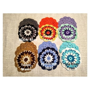 May include: A collection of handmade crochet coasters in various colors, including black, gray, orange, yellow, purple, iced mint, taupe, brown, periwinkle, navy, spa blue, and teal. Each coaster features a circular floral design.