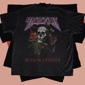 May include: Black t-shirt with a graphic of a skull with flowers and the text "YEEZY" and "All Dogs Go to Heaven".