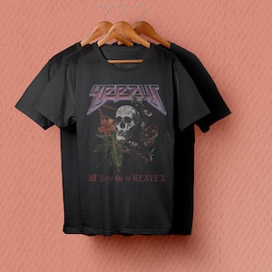 May include: Black t-shirt with a skull and floral design. The text "YEZZY" and "All Things Go to HEAVEN" are printed on the shirt.