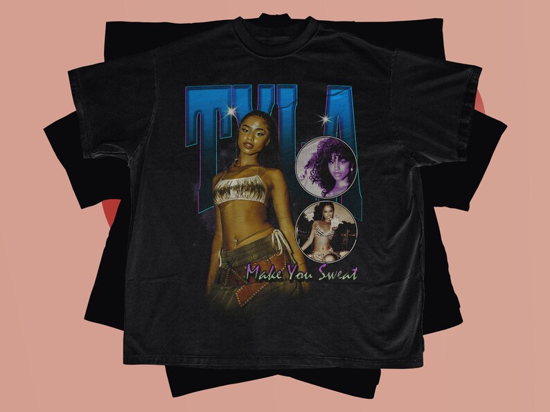 May include: Black t-shirt with a vintage-style graphic featuring a woman with the text "Tila Make You Sweat".
