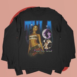 May include: Black long-sleeve t-shirt with a vintage-style graphic featuring a woman with the text "TILA Make You Sweat".