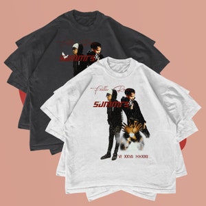 May include: Two white and black t-shirts with a graphic print of three people. The text on the white t-shirt reads "Fallen Royalty Summers" and "VI XXVII MMXXII".