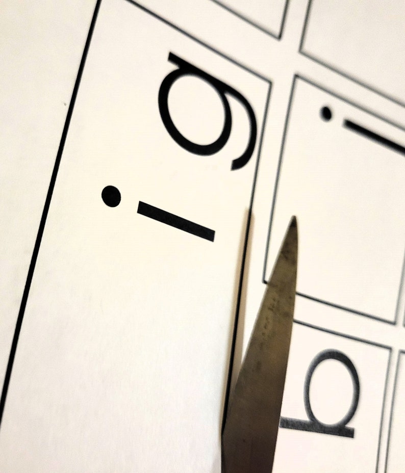 Photo of a printed word family sheet being cut with scissors. This resource is easy to assemble after downloading and printing. Suggested print each word family on a different color paper. Children can also make their own to take home.