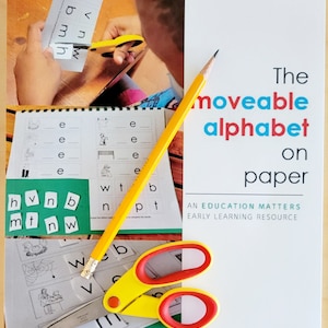 May include: A yellow pencil and scissors rest on a white paper with the text "The moveable alphabet on paper." The image shows a child cutting out letters from a worksheet. Educational resource for early learning.