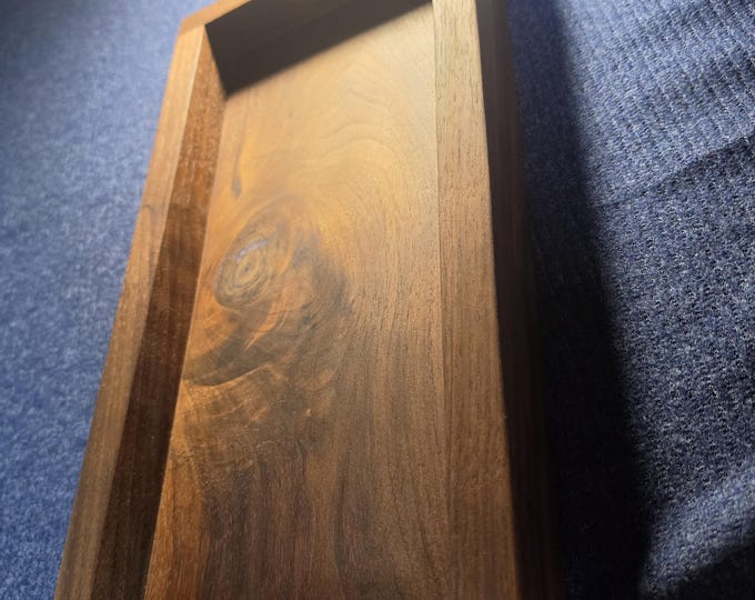 Custom black walnut valet tray with natural hole filled with blue/purple epoxy