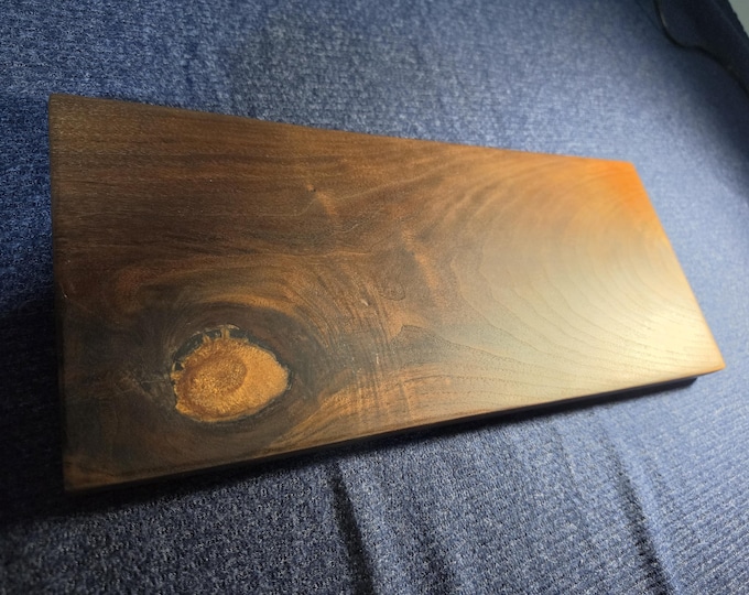 Custom Black walnut cutting/cheese board with a natural hole filled with a peachy copper epoxy