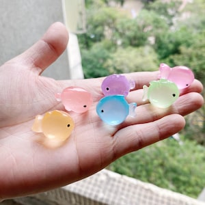 May include: A collection of six colorful, translucent, fish-shaped, squishy toys. The toys are made of a soft, pliable material and are perfect for squeezing and playing with.