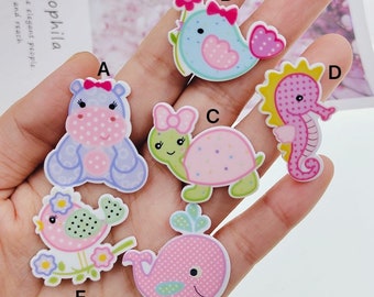 May include: Six colorful, cartoon animal appliques with polka dot patterns. The appliques include a hippopotamus, a bird, a turtle, a whale, a seahorse, and a bird with a flower.